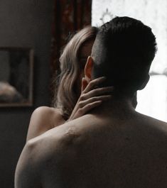 a naked man and woman are looking at each other