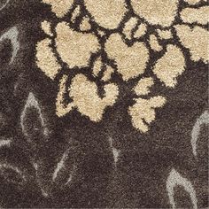 an area rug with flowers on it in brown and white colors, is shown here