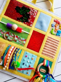 a close up of a colorful patchwork quilt with beads and other things on it