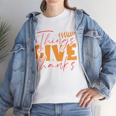 This Things Give Thanks' Thanksgiving design T-Shirt exudes a grateful and positive vibe, perfect for spreading thankfulness and joy. It is ideal for anyone looking to embrace the holiday spirit and express gratitude. Product features - Shoulder tape for added stability - Ribbed knit collar for elasticity - Made from strong and smooth fabric - Classic fit for comfy wear - Ethically grown and harvested US cotton Care instructions - Machine wash: warm (max 40C or 105F) - Non-chlorine: bleach as needed - Tumble dry: medium - Do not iron - Do not dryclean Be Thankful Shirt, Thankful Grateful Shirts, Fall Thankful Tshirt, Thankful Grateful Blessed Shirt, Thanksgiving Cotton Graphic Print T-shirt, Thanksgiving Design, Expressing Gratitude, Give Thanks, Festival Season