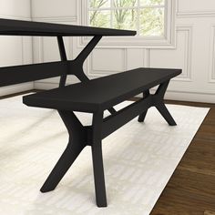 a black bench sitting on top of a white rug