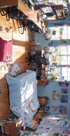 a room with many books on the floor and shelves full of children's books