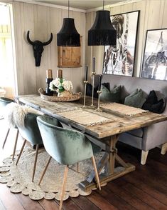 a dining room table with two chairs and a bench