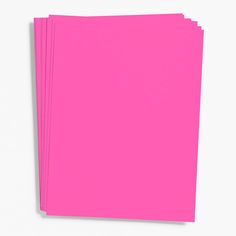 four bright pink paper sheets stacked on top of each other in front of a white background