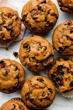 several chocolate chip muffins on a white surface