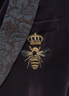 a bee with a crown on it's lapel is seen in this image