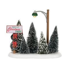 a christmas tree stand with a sign and street light in front of it that says, fresh out christmas trees