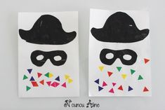 two paper bags with black and white masks on them