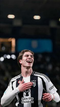 a soccer player is laughing and holding his hands together