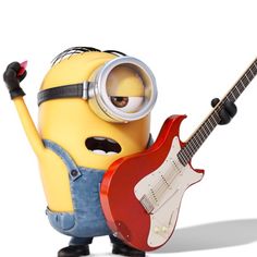 a minion holding a red guitar and wearing goggles with his arm in the air