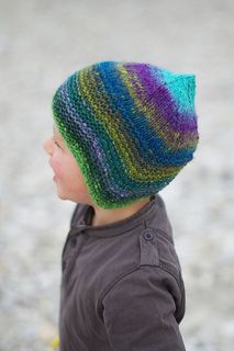 a young child wearing a multicolored knitted hat