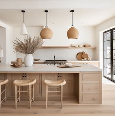 a large kitchen with wooden cabinets and stools