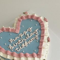 a heart shaped birthday cake with the words happy birthday written in frosting on it