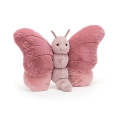 a pink butterfly stuffed animal sitting on top of a white surface