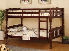 a wooden bunk bed sitting on top of a hard wood floor next to a potted plant