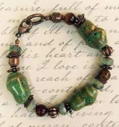 * This modern boho Bracelet goes with so many looks...the forest colors meld beautifully with almost any color palate! Capturing the outdoor shades are Picasso Beads, handmade Ceramic Beads, Copper Spacer Beads, and an Antique Copper Clasp. * Luscious, soft colorations of Mossy Green, Copper, Antique Copper, and Brown create a perfect marriage of Nature's colors. * The Bracelet is very comfortable to wear, and is available in several different lengths; please select your favorite length. * This Bohemian Turquoise Beaded Bracelets With Czech Glass, Bohemian Brown Beaded Copper Bracelets, Green Bohemian Bracelets With Patina, Green Czech Glass Beaded Bracelets, Bohemian Brown Czech Glass Bracelets, Forest Colors, Czech Beads Jewelry, Wire Wrapped Stone Jewelry, Mossy Green