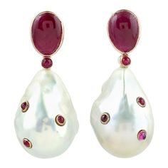 These pearl earrings are thoughtfully and meticulously crafted with 14 Karat yellow gold. It is set with 58.65 carats pearl and 6.51 carats ruby. FOLLOW MEGHNA JEWELS storefront to view the latest collection & exclusive pieces. Meghna Jewels is proudly rated as a Top Seller on 1stDibs with 5 star customer reviews. All items manufactured by us are handmade and can be customized or redesigned. Composition Size-37X15 MM Total Weight-17.63 Gold Weight(Gms)-4.598 Pearl Wt(Cts)-58.65 Ruby Wt(Cts)-6.51 Red Pearl Earrings For Formal Occasions, Elegant White Ruby Earrings, Pear-shaped Pearl Gemstone Earrings For Formal Occasions, Formal Pear-shaped Pearl Gemstone Earrings, Elegant Pear-shaped Ruby Jewelry, Elegant Red Pearl Earrings For Formal Occasions, Red Pearl Drop Earrings For Formal Occasions, Pearl Earrings Designs, Haute Jewelry