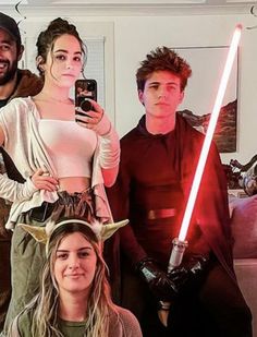 a group of people dressed up as star wars characters and one holding a cell phone