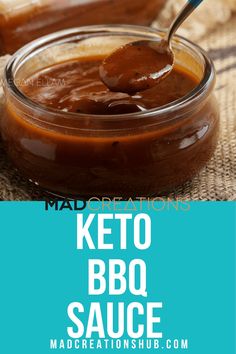 the keto bbq sauce is in a glass jar with a spoon on top