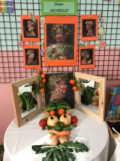 a table topped with fruit and vegetables on top of a white tablecloth covered table