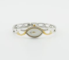 This sophisticated Accurist women's watch blends silver and gold tones to create a statement piece that's as versatile as it is beautiful. The elongated case, adorned on the right side with sparkling stone inlays, houses a delicate mother-of-pearl dial, enhancing its elegant allure. The metal bracelet offers a seamless look that complements any outfit, while its water resistance up to 30 meters ensures functionality alongside fashion. Presented in its original box, this timepiece combines durabi Stainless Steel Diamond Watch With Metal Dial As Gift, White Gold Analog Jewelry And Watches As Gift, White Gold Diamond Watch With Metal Dial As Gift, Watch Gift, Metal Bracelet, Stone Inlay, Waterproof Watch, Women Wrist Watch, Women's Watch