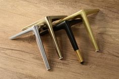 three different types of pens sitting on top of a wooden table