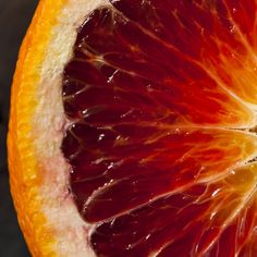 an orange cut in half sitting on top of a table