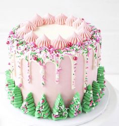 a pink and green decorated cake sitting on top of a white plate