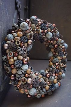 a wreath made out of seashells and pine cones