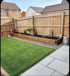 a backyard with grass and wooden fence