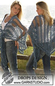 two women standing next to each other wearing crocheted shawls and jeans,