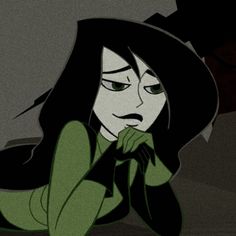 an animated image of a woman with long black hair and green eyes wearing a witches hat