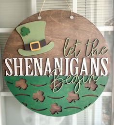 a wooden sign that says let the shennangans begin with shamrocks on it