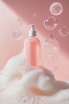 a bottle of soap sitting on top of a foamy surface with bubbles around it