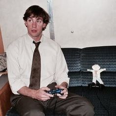 a man sitting on a couch holding a video game controller