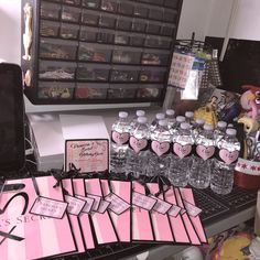 there are many water bottles and cards on the desk with other items in front of them