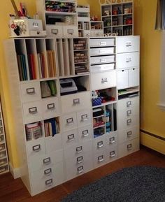 a room with many drawers and shelves filled with craft supplies