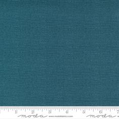 a blue fabric with a ruler in front of it