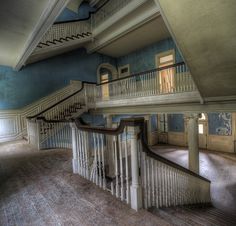 an empty room with stairs and blue walls