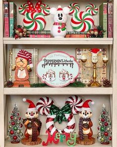 the shelves are decorated with christmas decorations and mickey mouse figurines, candy canes