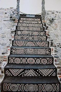 an artistic stair case painted with black and white designs