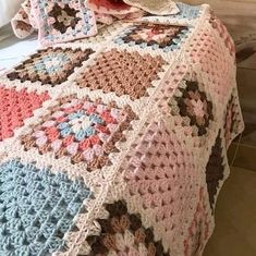 a crocheted blanket is draped over a bed