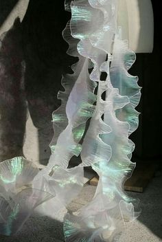 a sculpture made out of plastic sitting on the ground