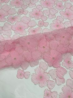 pink flowers on white fabric with gold sequins