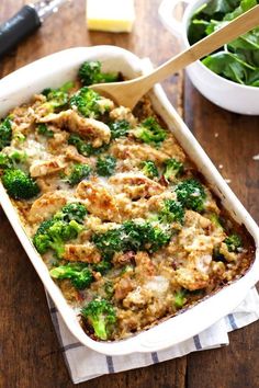 a casserole dish with broccoli and meat in it on a wooden table