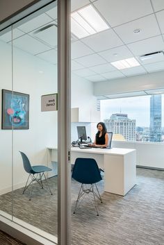 a woman sitting at a desk in an office