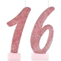 the number sixteen candle has pink glitter on it's top and stands in front of a white background