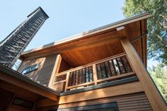 a tall wooden building sitting next to a forest