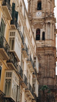 an old clock tower with balconies and balconies on the side of it