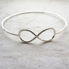 "Sterling Silver Infinity Bangle~ Beautiful sterling silver infinity symbol bangle, custom made for you! Hammered and polished for that extra sparkle! Looks great worn with one or more! Perfect gift for a friend or sweetheart. This listing is for a sterling silver hammered infinity symbol bangle like the one pictured, you choose the size and if you want 14 gauge or a thicker 12 gauge. Please view the last picture on this listing that shows how to measure for your correct size as there will be a Sterling Silver Infinity Bracelets For Anniversary, Silver Infinity Bracelet For Anniversary, Sterling Silver Infinity Bracelet For Anniversary, Adjustable Sterling Silver Bangle For Wedding, Nickel-free Sterling Silver Bangle For Wedding, Adjustable Silver Bangle For Bridesmaid Gift, Tahitian Pearl Ring, Hammered Bracelet, Bracelet Friendship